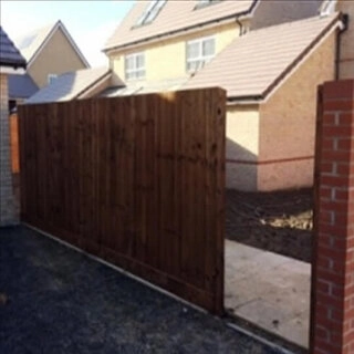 Feather edged closeboard fence with gate